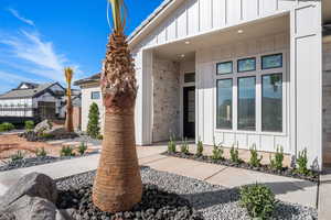 Entrance to property featuring board and batten siding and stone siding