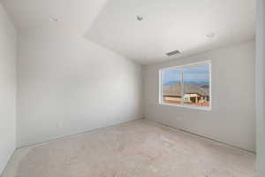 Spare room with lofted ceiling and a mountain view