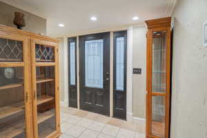 Foyer entrance with a textured wall, light tile patterned floors, a sauna / steam room, and recessed lighting