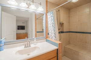 Full bathroom with vanity and a shower stall