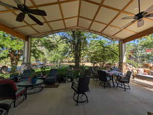 View of patio with ceiling fan and outdoor dining space