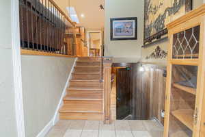Stairs featuring tile patterned floors