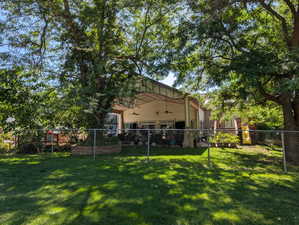 View of yard featuring a ceiling fan and a patio area
