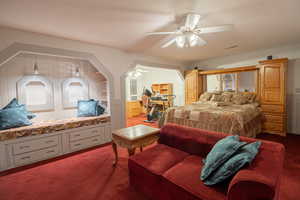 Bedroom with carpet flooring, an office area, and ceiling fan