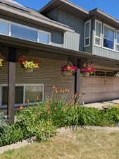 View of property exterior featuring brick siding and solar panels