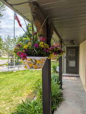 Entrance to property featuring a lawn and brick siding
