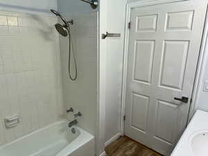 Bathroom with  shower combination, vanity, and dark wood finished floors