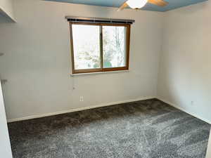 Empty room featuring carpet floors and ceiling fan