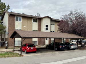 View of property with covered parking