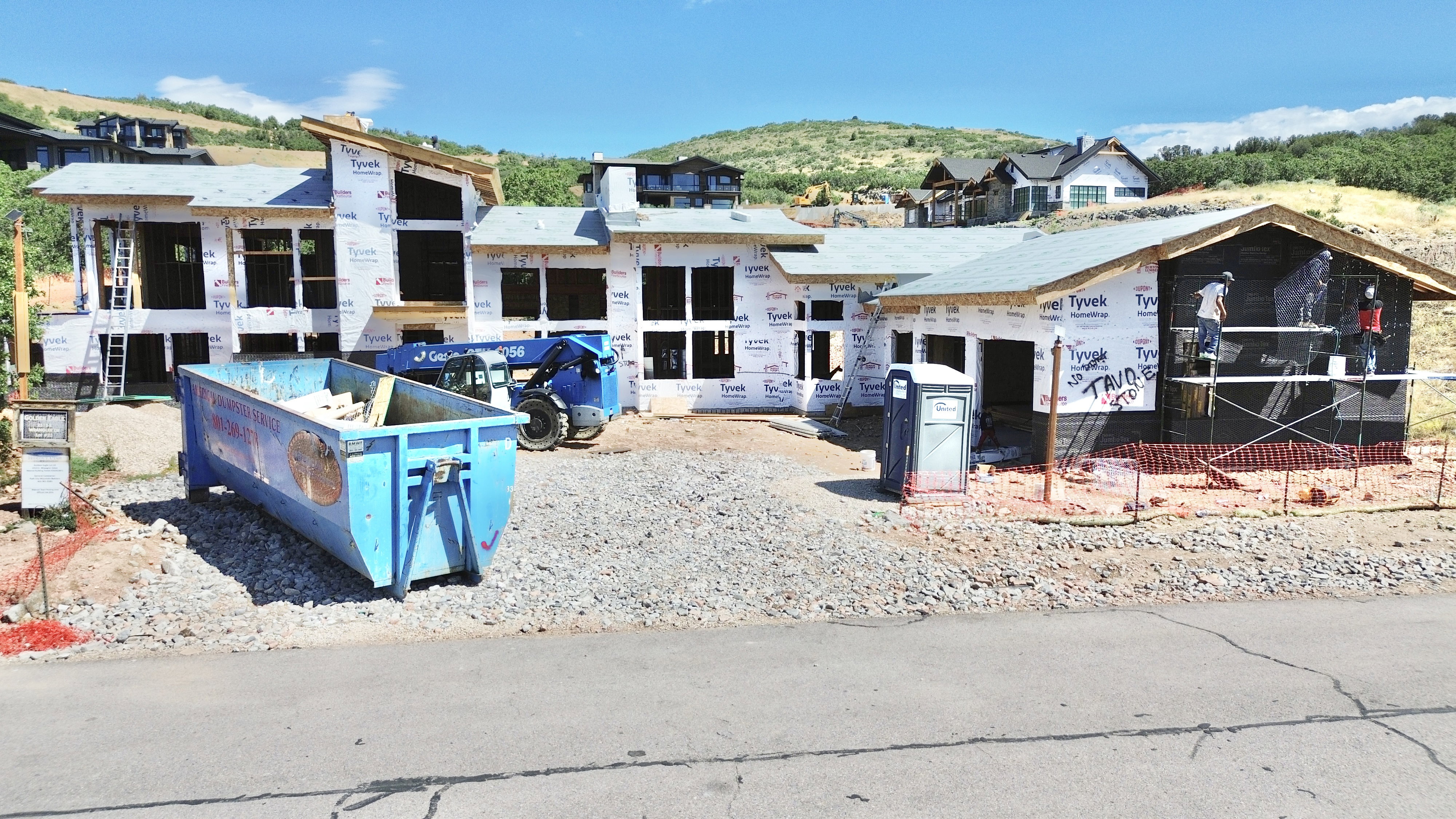 New construction opportunity featuring a modern architectural design, multiple large window openings, and a prominent hillside setting