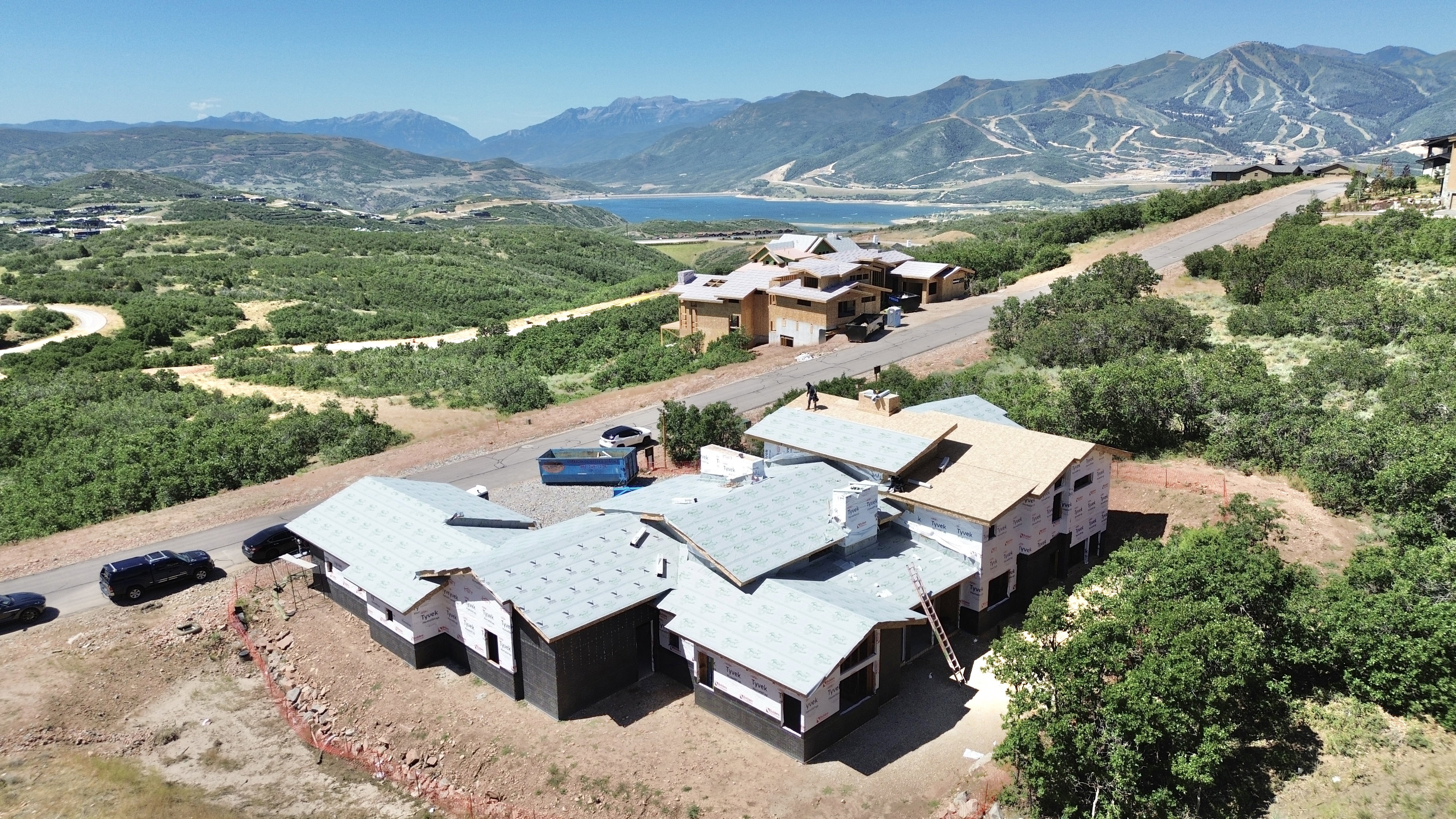 New construction property featuring multiple rooflines and a sloped lot