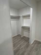 Walk in closet featuring light wood-type flooring