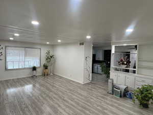 Unfurnished living room featuring light wood finished floors and recessed lighting