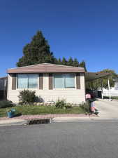 Manufactured / mobile home with an attached carport and concrete driveway