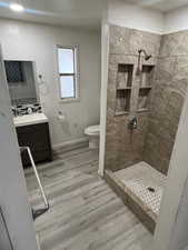 Bathroom with a stall shower, vanity, and light wood finished floors