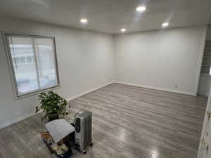Unfurnished room featuring wood finished floors and recessed lighting