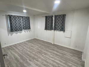 Empty room with wood finished floors and recessed lighting