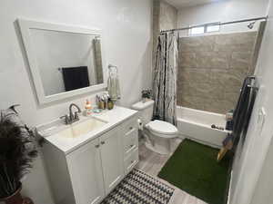 Full bath with shower / bath combo with shower curtain and vanity