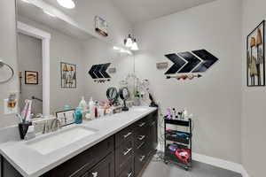 Bathroom with double vanity and light tile patterned floors
