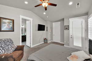 Bedroom with lofted ceiling, light colored carpet, a ceiling fan, recessed lighting, and connected bathroom