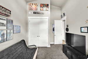 Living area featuring high vaulted ceiling and carpet floors