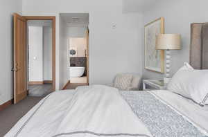 Bedroom with carpet floors and connected bathroom