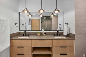 Bathroom with double vanity and a stall shower