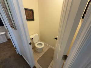 Bathroom featuring toilet and tile patterned flooring