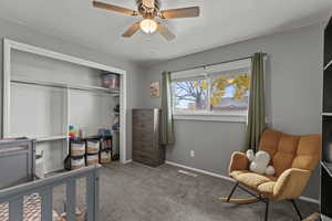 Bedroom with light carpet, a closet, and ceiling fan