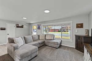 Living area featuring light carpet