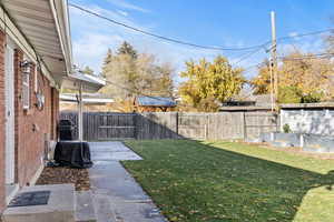 Fenced backyard featuring a patio