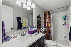 Bathroom featuring a stall shower, vanity