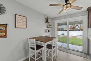 Dining room with light wood-style flooring and ceiling fan