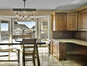 Dining with built in desk and cabinetry.