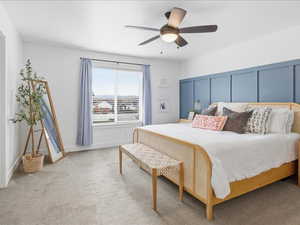 Bedroom with light colored carpet and ceiling fan