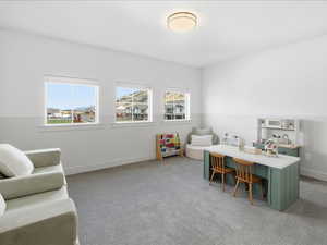 Home office featuring light colored carpet