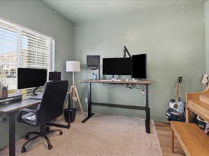 Office with light wood-style floors and baseboards