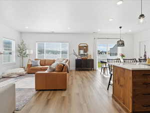 Living room featuring light wood finished floors and recessed lighting
