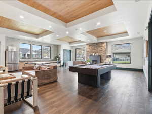 Game room featuring wooden ceiling, a stone fireplace, billiards, and recessed lighting