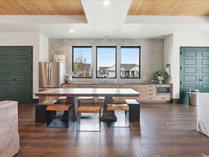 Dining area with wooden ceiling, dark wood-style flooring, and recessed lighting