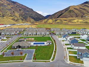 Aerial view of property and surrounding area with nearby suburban area and mountains