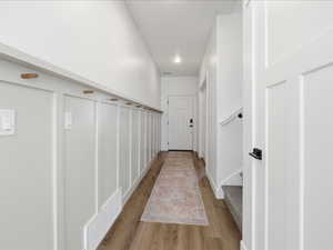 Hall featuring wood finished floors and baseboards