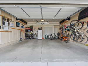 Garage featuring freestanding refrigerator