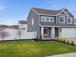 Craftsman house featuring covered porch, roof with shingles, board and batten siding, and an attached garage