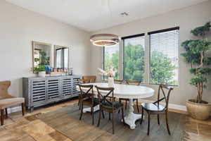 Dining room with stone tile flooring and baseboards