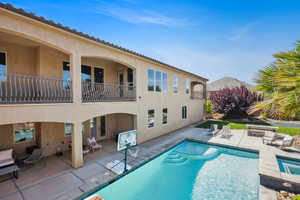 Swimming pool featuring a patio area and a balcony