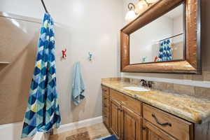 Bathroom featuring vanity and a shower with shower curtain