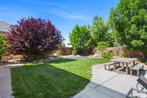 Fenced backyard featuring a patio area and outdoor dining area