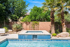 View of swimming pool with a patio area, an in-ground hot tub, and a fenced backyard