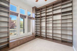 Spacious closet featuring a ceiling fan and wood finished floors
